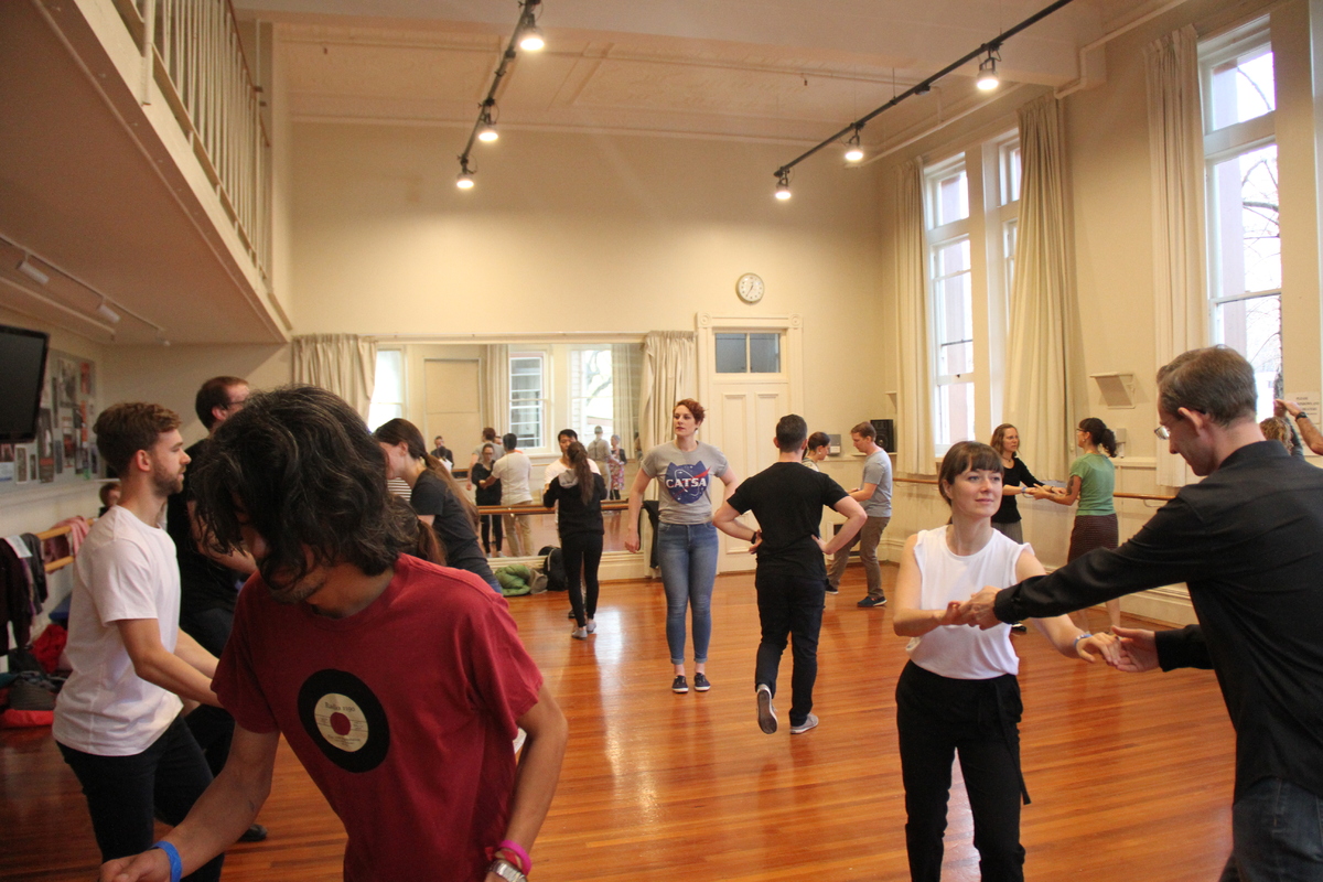 A dance studio with dancers learning lindy hop